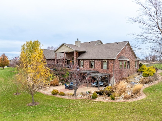 back of property featuring a patio, brick siding, a lawn, a pergola, and a chimney