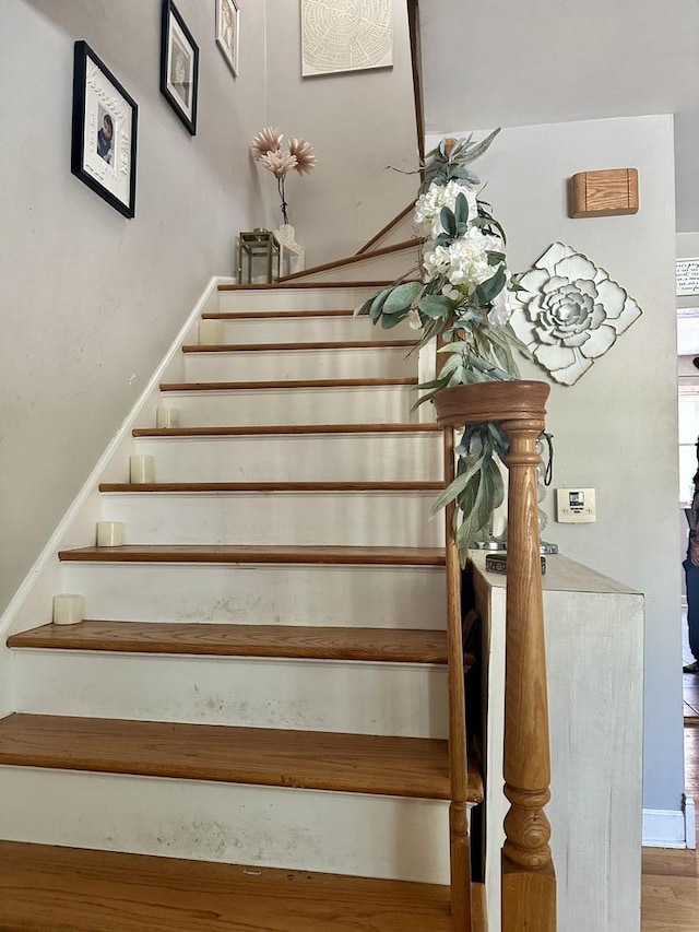 stairway with hardwood / wood-style floors