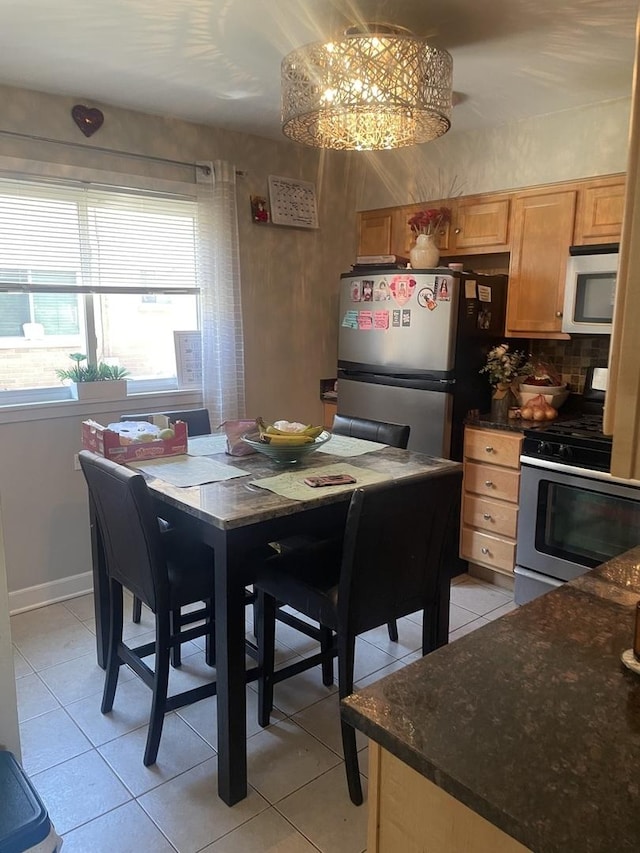 tiled dining area with a notable chandelier