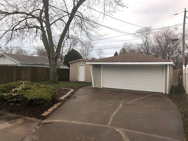 detached garage featuring fence