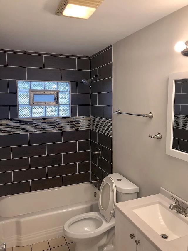 full bath featuring  shower combination, tile patterned flooring, toilet, and vanity