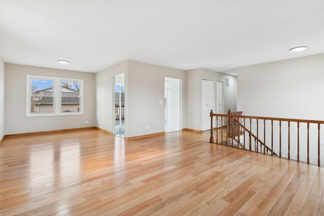 unfurnished room with light hardwood / wood-style flooring