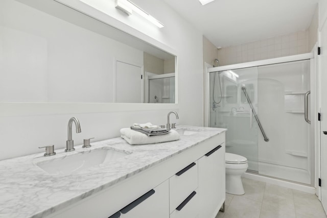 bathroom featuring vanity, a shower with door, tile patterned floors, and toilet