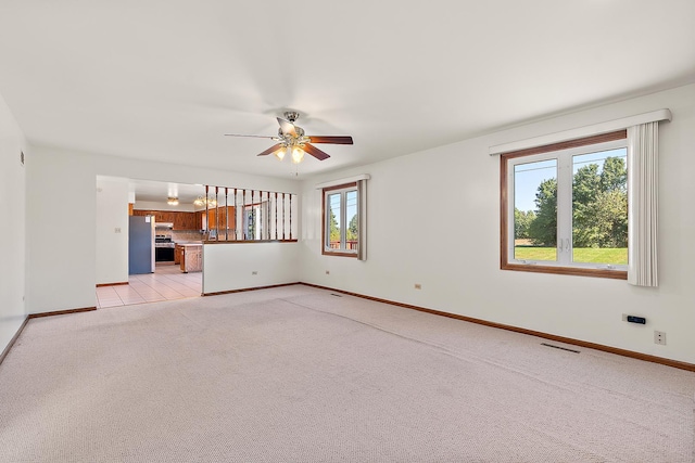 unfurnished living room with light carpet and ceiling fan