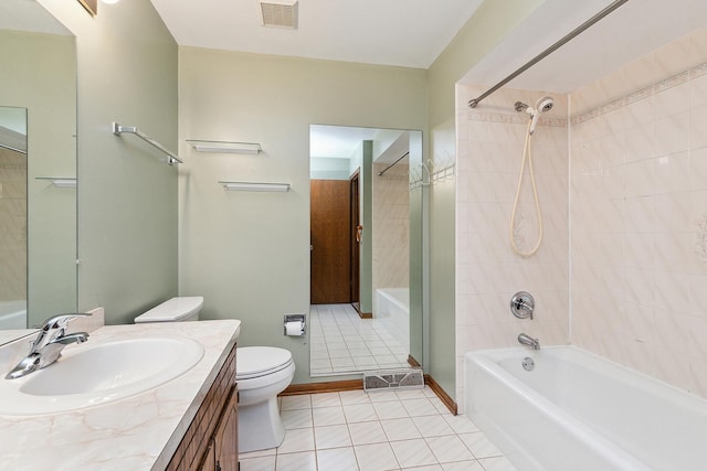 full bathroom with tile patterned floors, vanity, tiled shower / bath combo, and toilet