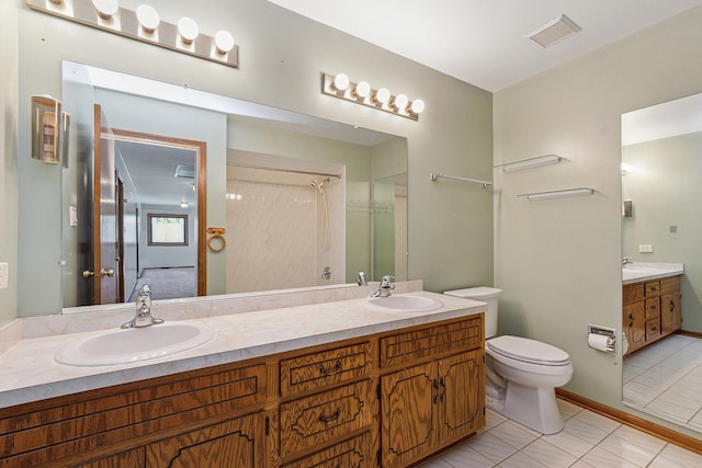 bathroom featuring tile patterned floors, vanity, and toilet