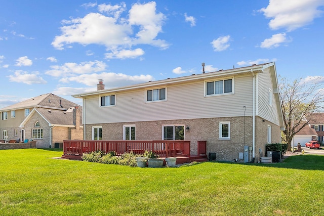 back of property featuring central AC unit, a deck, and a yard