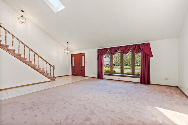 unfurnished living room with carpet floors and high vaulted ceiling