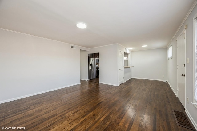 unfurnished living room with crown molding and dark wood-type flooring