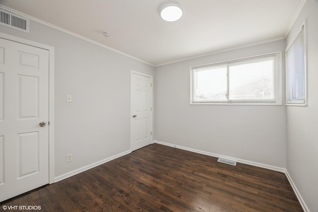 unfurnished room with dark hardwood / wood-style flooring and crown molding