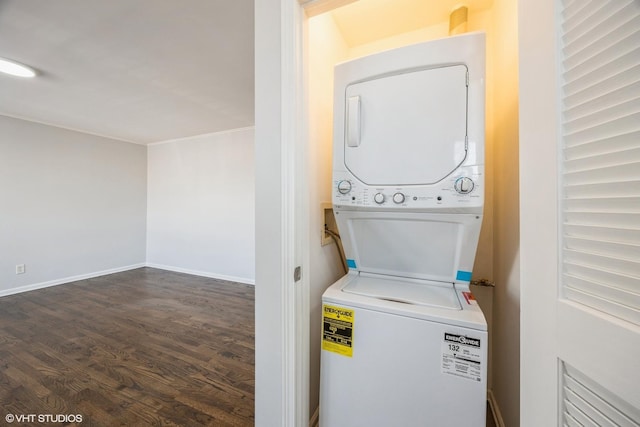 washroom featuring dark hardwood / wood-style floors and stacked washer and clothes dryer