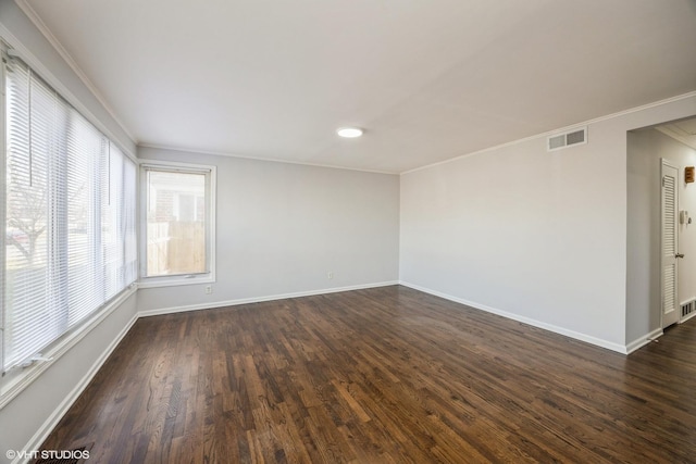 empty room with crown molding and dark wood-type flooring