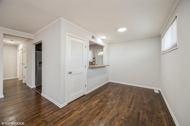 unfurnished room featuring crown molding and dark hardwood / wood-style flooring