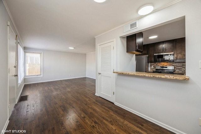 kitchen featuring tasteful backsplash, dark brown cabinets, stainless steel appliances, crown molding, and dark wood-type flooring