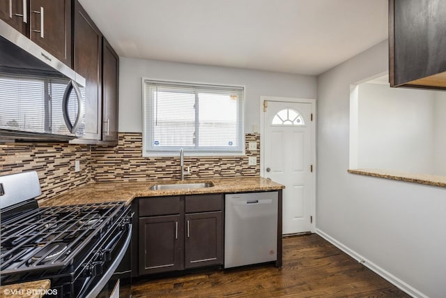 kitchen with dark hardwood / wood-style flooring, sink, stainless steel appliances, and dark brown cabinets