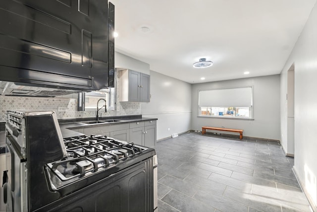 kitchen with backsplash, a wealth of natural light, gray cabinetry, and black range with gas cooktop