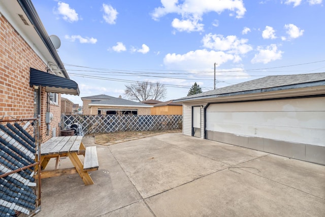 view of patio featuring a garage and an outdoor structure