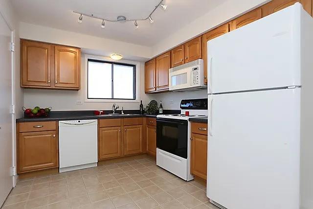 kitchen with white appliances and sink