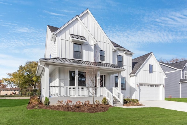 modern farmhouse featuring covered porch, a front yard, and a garage