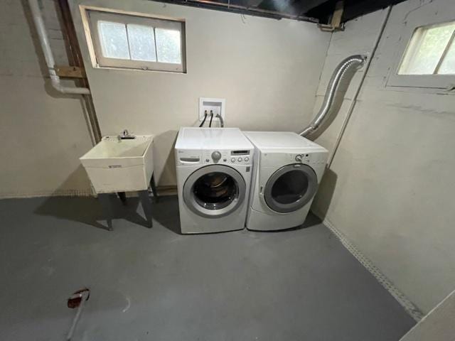 laundry area featuring laundry area, independent washer and dryer, and a sink