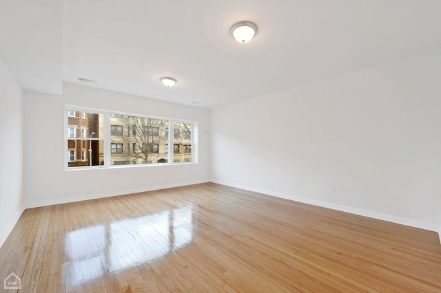 unfurnished room with light wood-type flooring