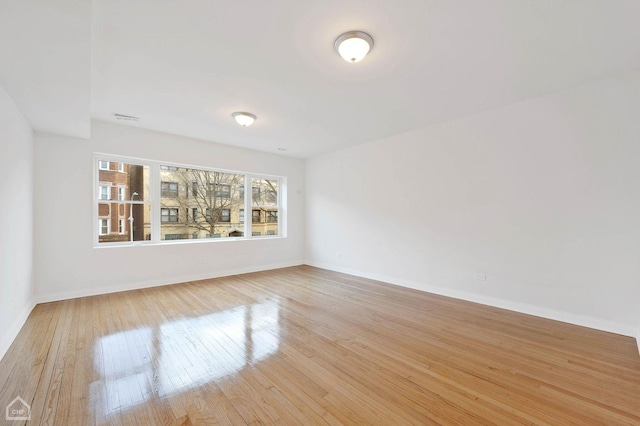 spare room featuring light hardwood / wood-style floors