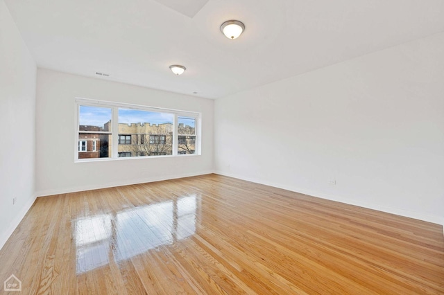 empty room with light hardwood / wood-style flooring