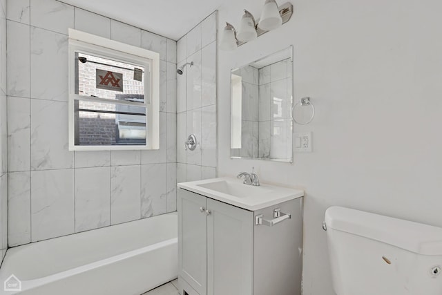 full bathroom with vanity, toilet, and tiled shower / bath combo