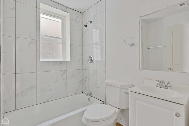 full bathroom featuring vanity, toilet, and tiled shower / bath