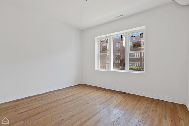 spare room with light hardwood / wood-style floors