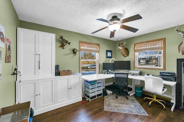 home office with ceiling fan, dark wood-type flooring, and a textured ceiling