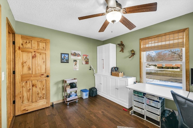 interior space with ceiling fan, dark hardwood / wood-style floors, and a textured ceiling