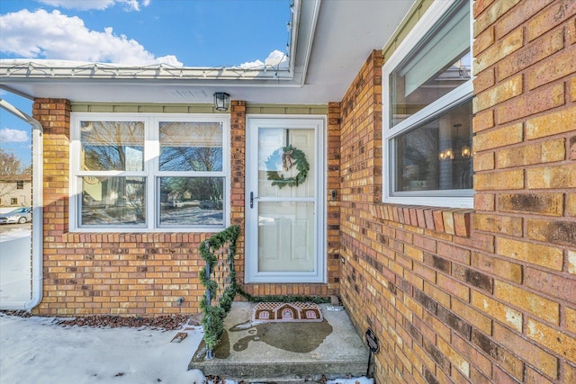 view of snow covered property entrance