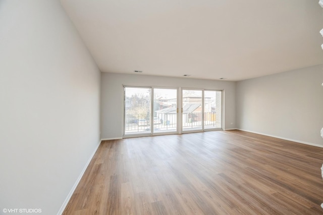 empty room with light hardwood / wood-style floors