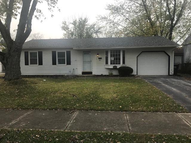 single story home featuring a front lawn, driveway, and an attached garage