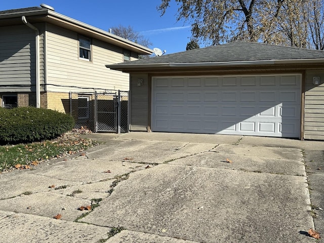 view of property exterior with a garage and an outbuilding