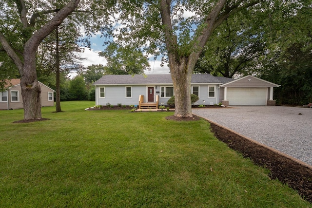 ranch-style home featuring a garage, gravel driveway, and a front yard