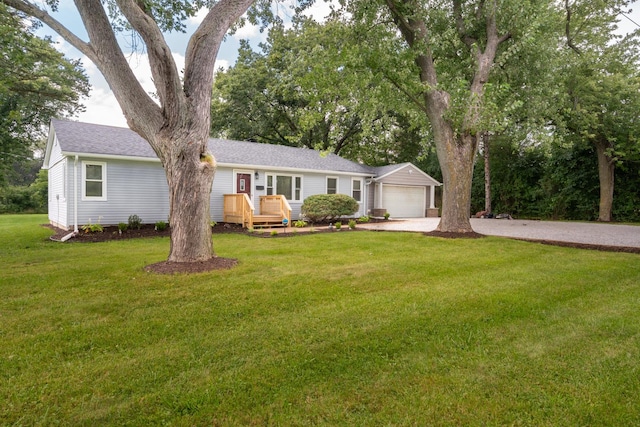 single story home with a garage, driveway, a front yard, and a wooden deck