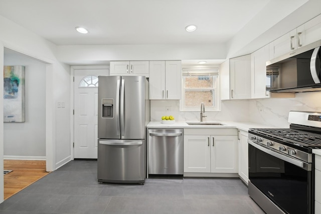 kitchen with white cabinets, appliances with stainless steel finishes, sink, and plenty of natural light