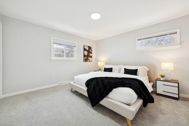 bedroom featuring light carpet