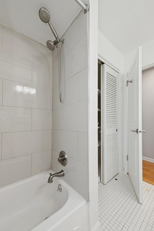 bathroom featuring tile patterned floors and tiled shower / bath