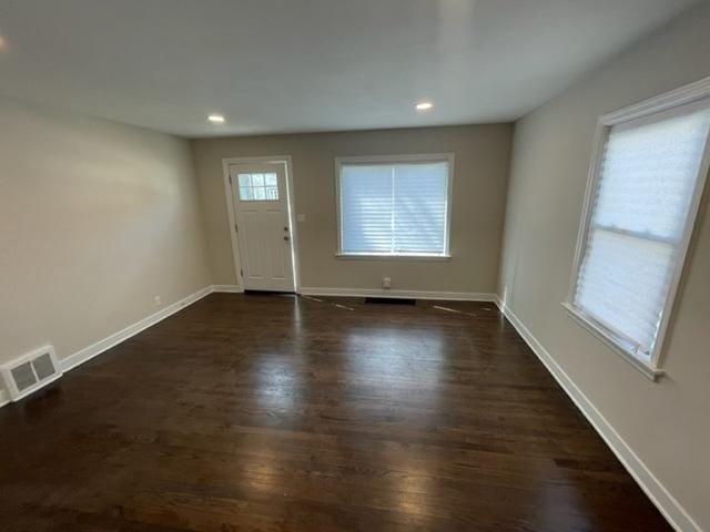 entryway with dark wood-style flooring, recessed lighting, visible vents, and baseboards