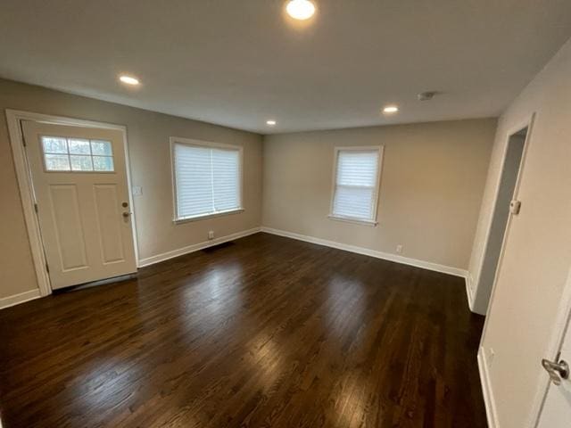 entryway with dark wood-style floors, recessed lighting, and baseboards