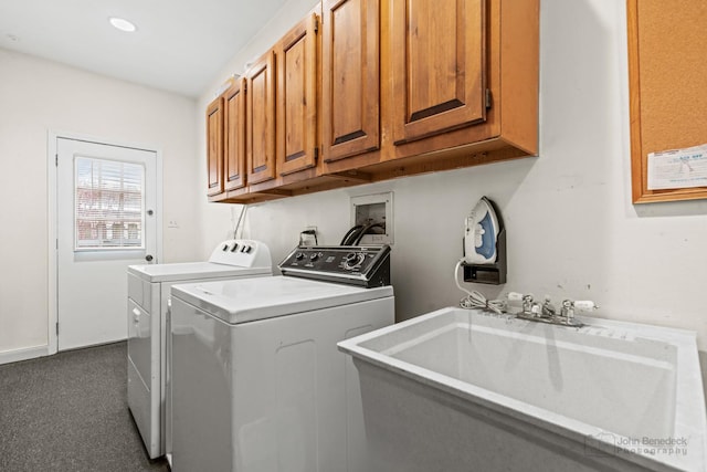 laundry area with cabinets, sink, washer and dryer, and dark colored carpet