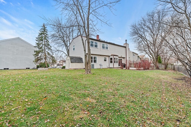 rear view of property featuring a lawn