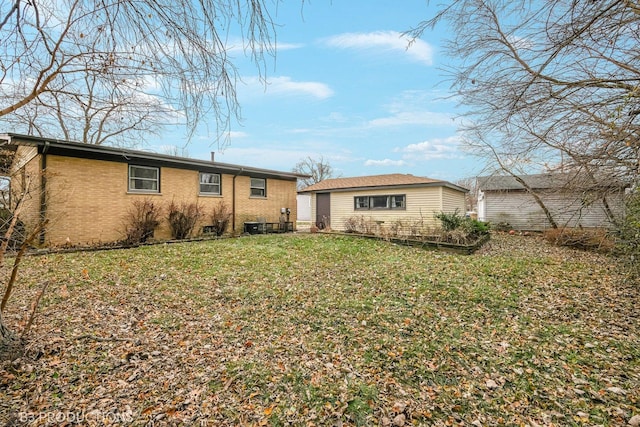 rear view of property with a yard