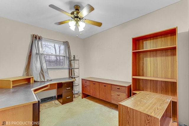 carpeted home office with ceiling fan