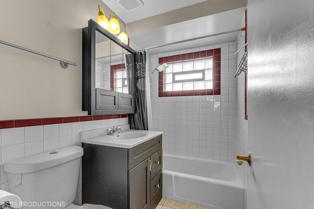 full bathroom featuring shower / tub combo, vanity, tile walls, tile patterned flooring, and toilet