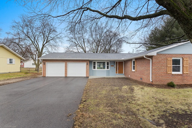 ranch-style home featuring a garage and a front lawn