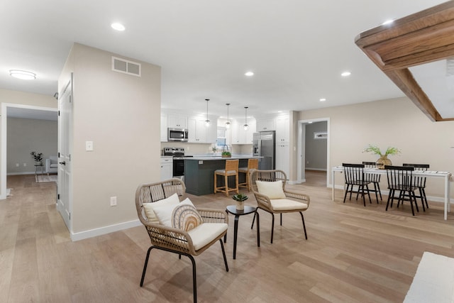 living room with light hardwood / wood-style flooring